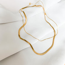 Load image into Gallery viewer, 18k gold filled herringbone chain. A classic necklace that never goes out of style. High quality, tarnish resistant. Shown layered with a thin snake chain.
