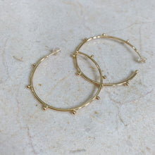 Load image into Gallery viewer, 18k gold filled thin hoop earrings with ball stud detail. Open hoop, push back closure. Lightweight, high quality, tarnish resistant. Shown in 1.75 inches size.