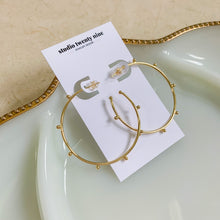 Load image into Gallery viewer, 18k gold filled thin hoop earrings with ball stud detail. Open hoop, push back closure. Lightweight, high quality, tarnish resistant. Shown in 1.75 inches size.