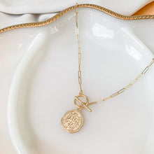 Load image into Gallery viewer, 14k gold filled paperclip link chain connected with a front toggle clasp and a rustic gold coin pendant. High quality, tarnish resistant. Chain length is customizable.

