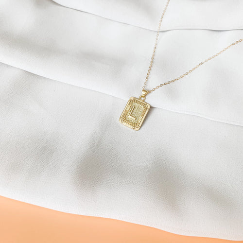 Unapologetically You - 14k gold filled rectangle initial necklace. Tag pendant with uppercase letter on cable chain. High quality, tarnish resistant.