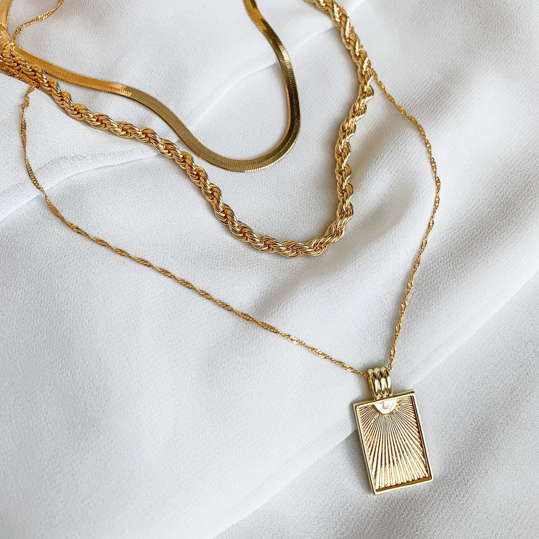 18k gold filled 3 layer necklace set including a herringbone chain, a rope chain, and rectangle sunburst pendant on a thin twisted rope chain. High quality, tarnish resistant.