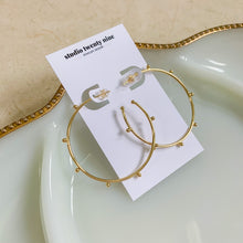 Load image into Gallery viewer, 18k gold filled thin hoop earrings with ball stud detail. Open hoop, push back closure. Lightweight, high quality, tarnish resistant. Shown in 1.75 inches size.
