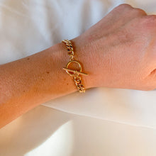 Load image into Gallery viewer, 18k gold filled Cuban curb chain bracelet with toggle clasp. High quality, tarnish resistant. Shown on petite wrist.
