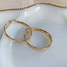 Load image into Gallery viewer, 18k gold filled thick hoop earrings. Wide, flat, continuous hoop style with lever closure. Lightweight. High quality, tarnish resistant.
