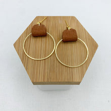Load image into Gallery viewer, Brown and gold earrings made with genuine leather looped on a gold hoop. Minimalist and lightweight for everyday. Ball post stud.
