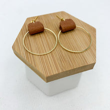 Load image into Gallery viewer, Brown and gold earrings made with genuine leather looped on a gold hoop. Minimalist and lightweight for everyday. Ball post stud.

