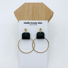 Load image into Gallery viewer, Black and gold earrings made with genuine leather looped on a gold hoop. Minimalist and lightweight for everyday. Ball post stud.
