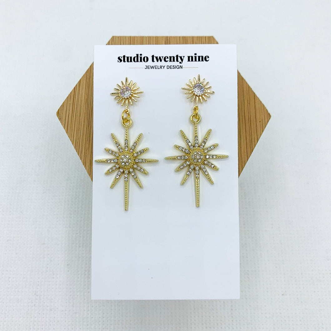 Bold, chic gold starburst CZ dangle earrings with a sparkly style that catches the light in a beautiful way. High quality, hypoallergenic 24k gold plated posts.